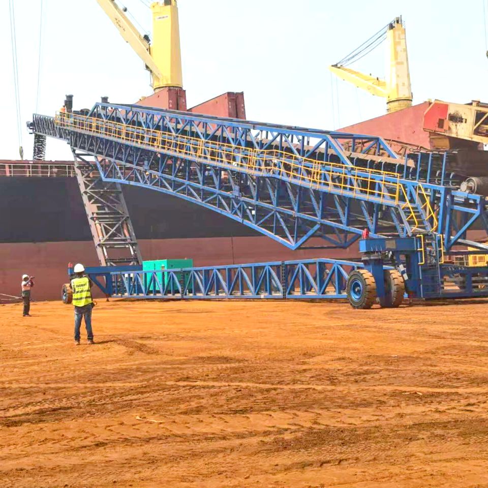 Engineer inspecting ship loader wheel bearing and rail joint for abnormal noise